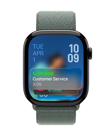Apple Watch in Jet Black with Sage strap, face shows Call Assistant notification at the bottom, date at top left, time numerals stacked at top right