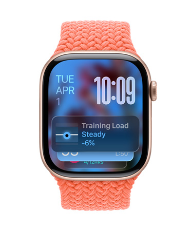 Apple Watch in Rose Gold with a braided strap in Tangerine, face shows date at top left, time with stacked numerals at top right, Training Load widget at the bottom, all in translucent Liquid Glass