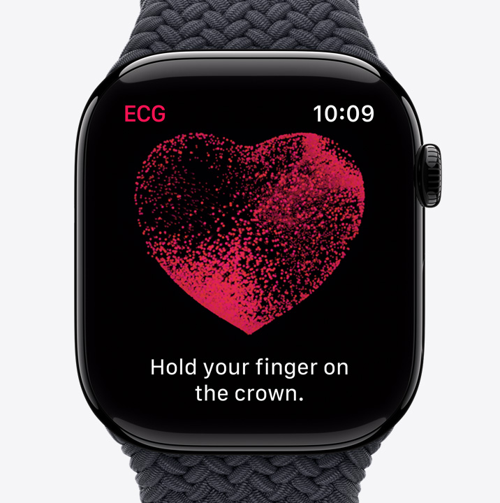 The ECG app showing a red heart with particles moving inside. Text says "Hold your finger on the crown."